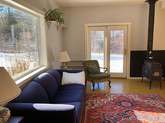 Concrete floors become cozy with radiant heat and an added carpet.
