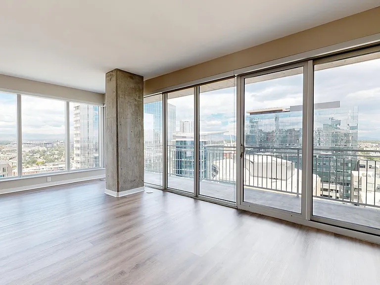 Apartment dining and living room with wood-style flooring.