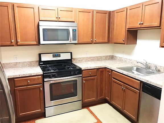 Kitchen with stainless steel appliances. Hardwood floor.