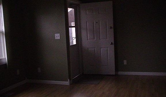 Another angle of living room viewing front door to enter pro