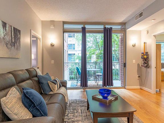 Open living room with large adjacent balcony.