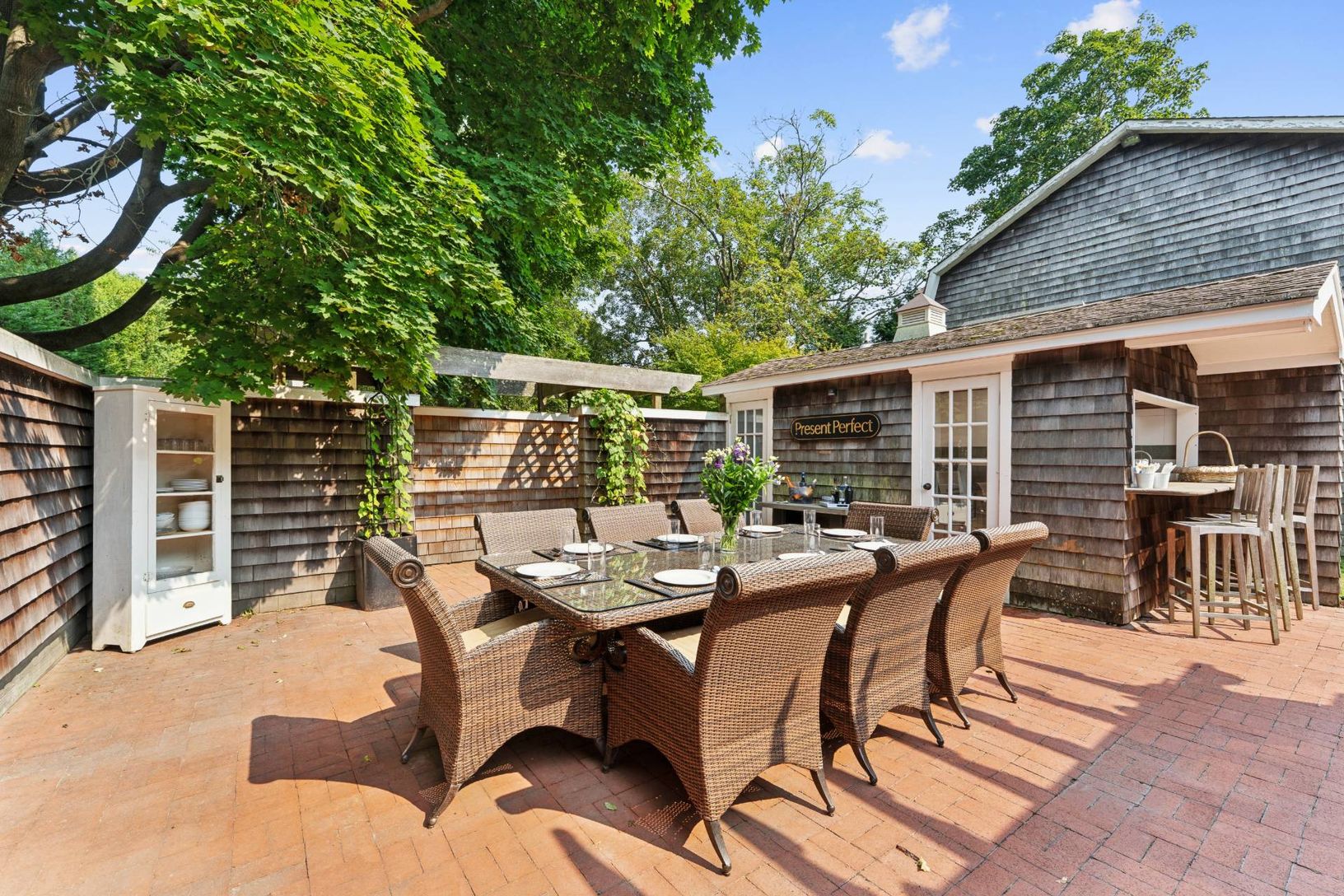 Dining for 8 with view toward outdoor kitchen and counter seating