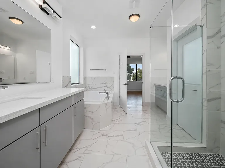 Primary bath with double vanities, free standing shower, and overized tub