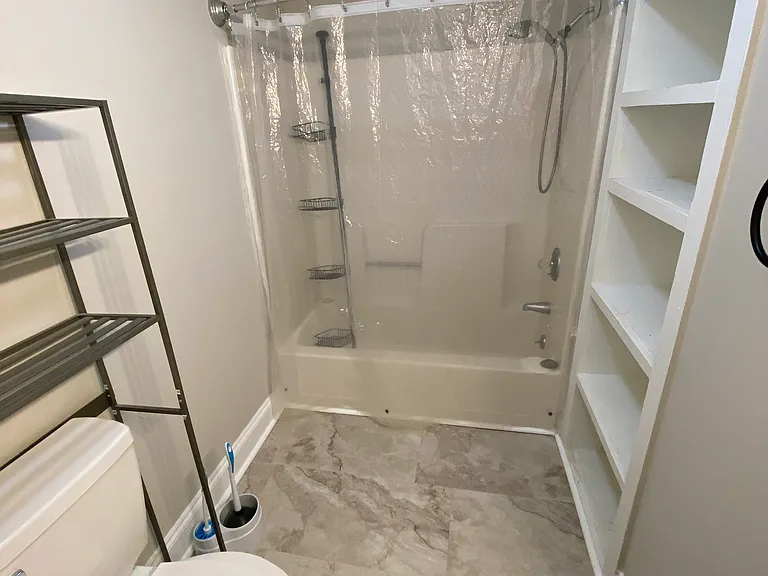 Bathroom which has a second large walk-in closet and nice shelves for towels and storage. Bathroom vanity, floor and toilet was updated.