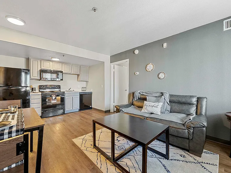 Experience contemporary urban living with this stylish open-plan living room and kitchen space.
