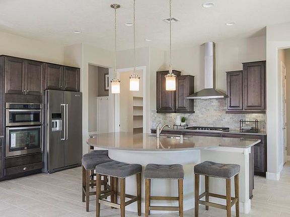 Culinary kitchen offers stainless steel appliances, stacked oven and microwave combo, vent hood and