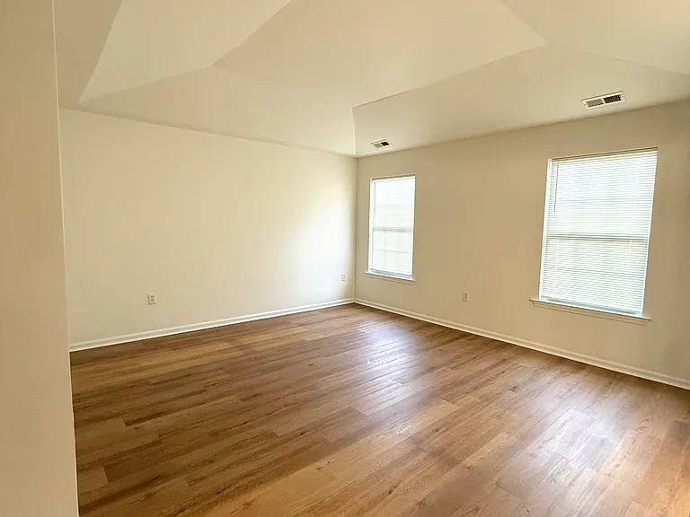Primary bedroom with vaulted ceilings