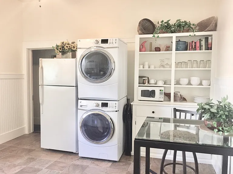 New washer dryer, plenty of cabinets and a table in the Kitchen, range and sink on other side of kitchen