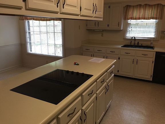 The eat in kitchen has a large bar, jenn aire stovetop, buil