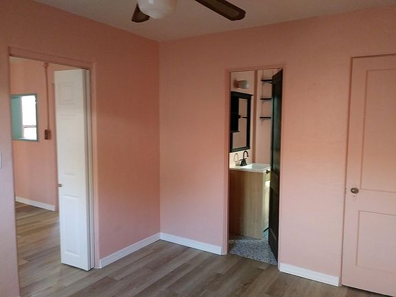 View into living room on left and bathroom with new vanity on right