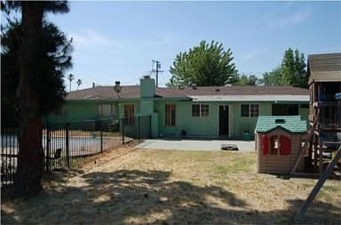 back w/a fenced pool