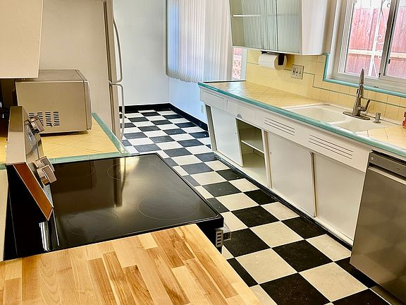 Fun kitchen with a 50's vibe has new butcher block, range and dishwasher.