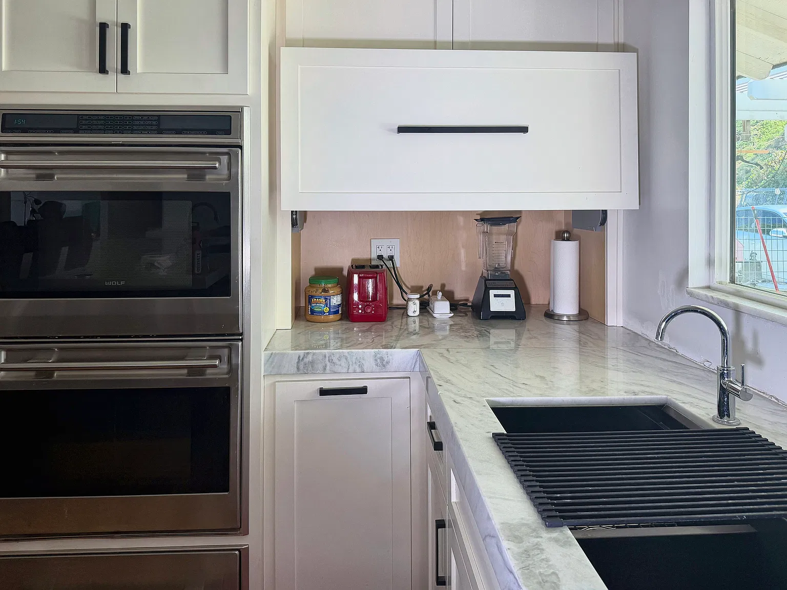 Wolf double wall oven and warmer drawer, plus an appliance garage that keeps the counters clear.