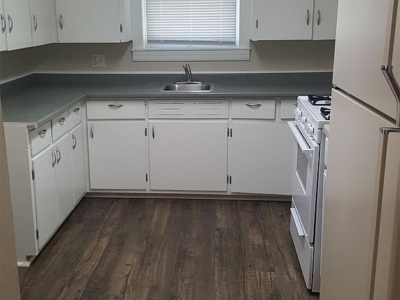 Kitchen has new flooring with the laundry room off to the left of this picture.