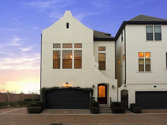 An end unit, this patio home has additional parking on the side and a small side yard. This gated co
