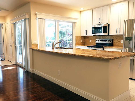 Kitchen with new SS appliances and granite counters.