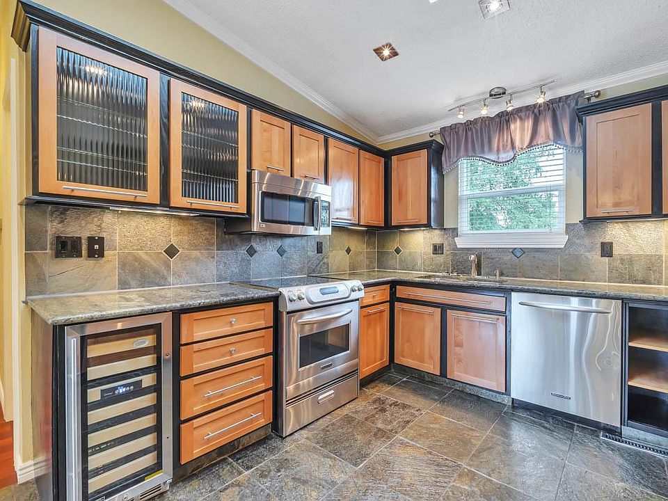 MAIN LEVEL KITCHEN WITH GRANITE COUNTERS, STAINLESS STEEL APPLIANCES & WINE COOLER