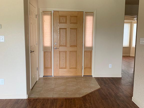 Front Door with side windows covered for privacy, cellular blinds roll up to peek out/allow more light