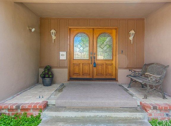 The solid wood, double door entry with decorative glass welcomes you as you step up to the spacious, oversized, front porch.