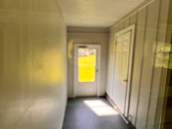 Hallway off of kitchen
- not pictured, to the right is access to the backyard
- straight ahead is access to the side yard
- The closed door on the right is the laundry room