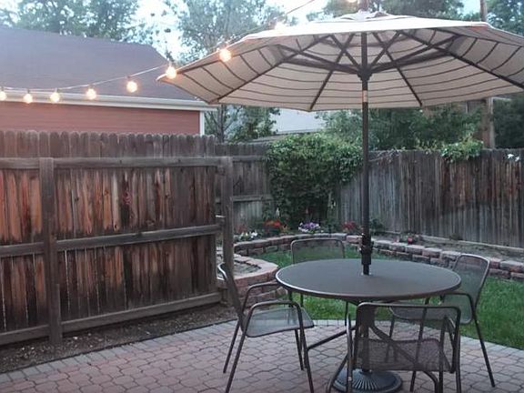 Great patio and backyard with raised flowerbeds