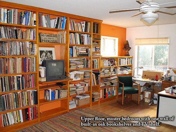 Upper master bedroom w/ built in bookshelves