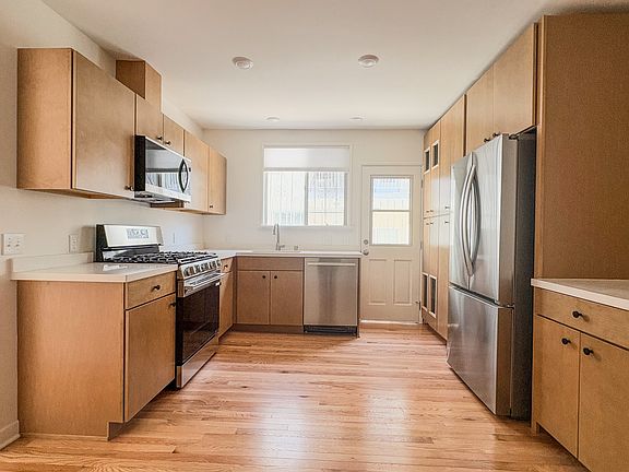 Kitchen with brand new stainless steel appliances, quartz countertops, and maple cabinets