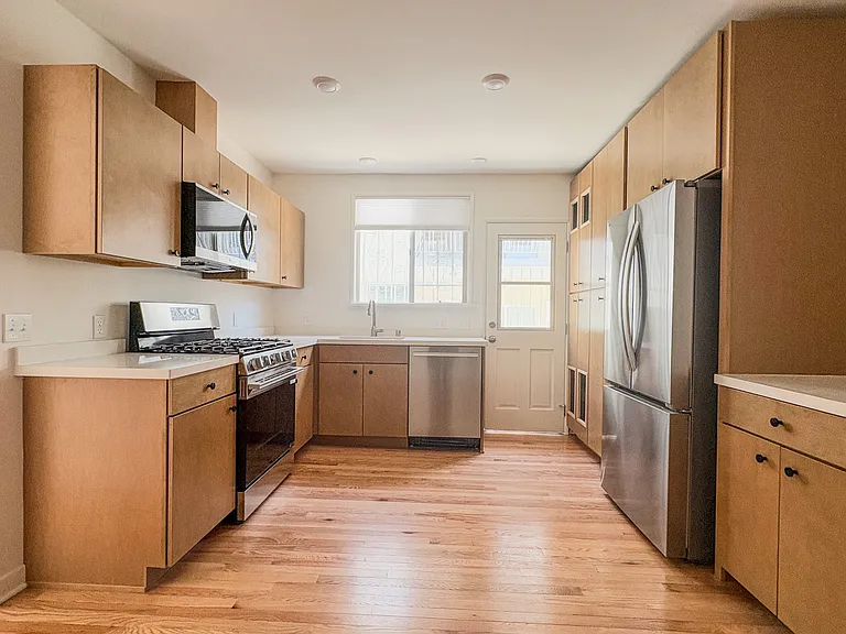 Kitchen with brand new stainless steel appliances, quartz countertops, and maple cabinets