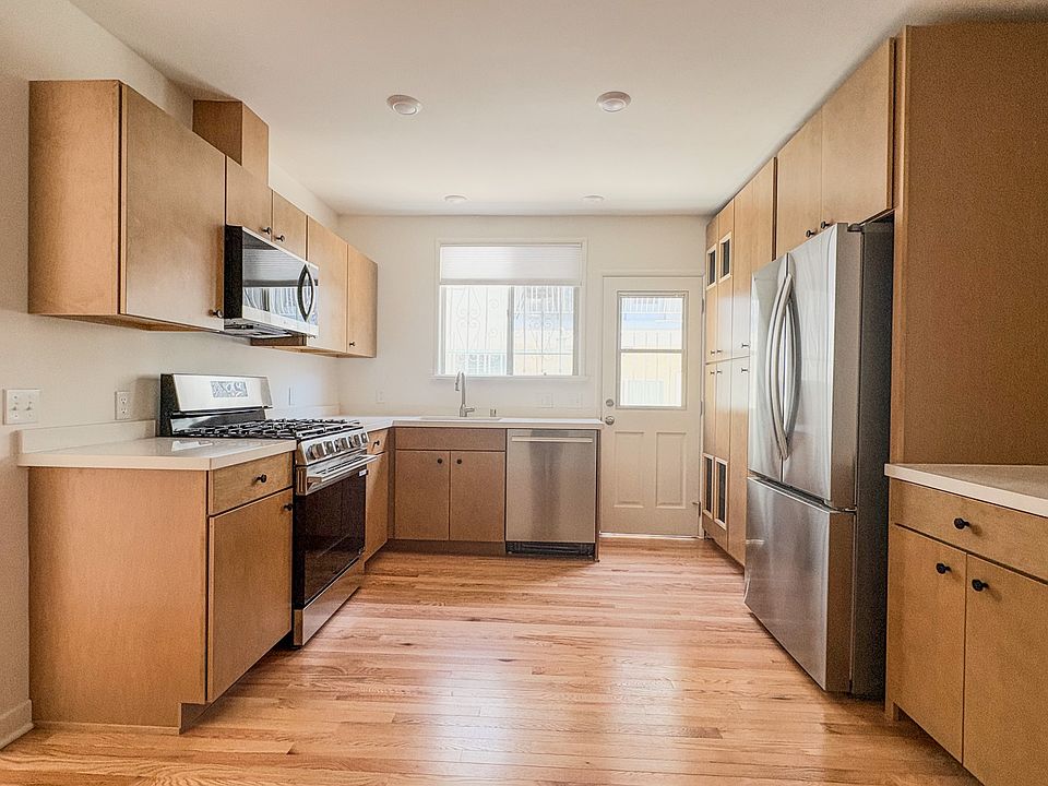Kitchen with brand new stainless steel appliances, quartz countertops, and maple cabinets