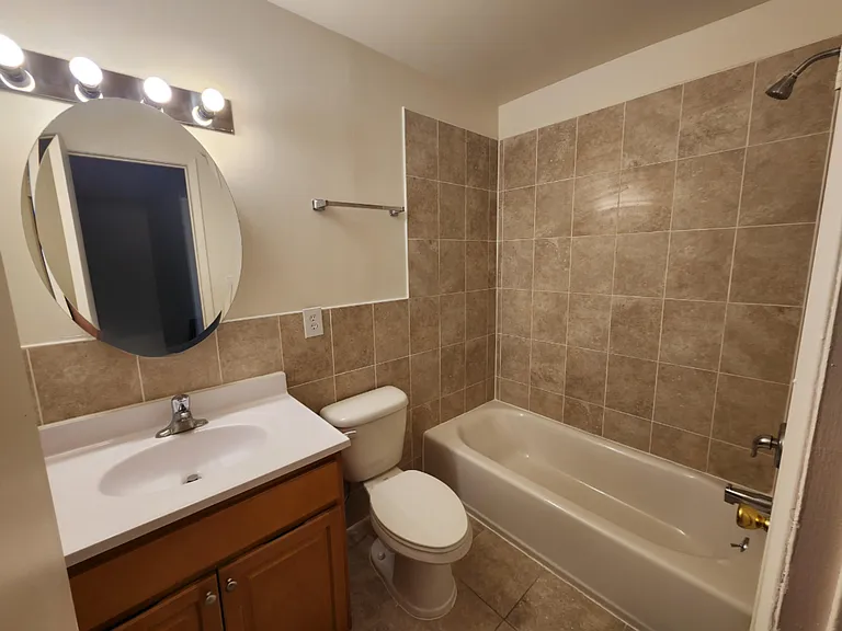 Main Bath: Updated/Renovated. Color of tile may vary.