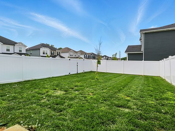Large, fully fenced backyard offering privacy, green space, and plenty of room to enjoy the outdoors. Features two gates_a 4-foot and a 10-foot gate_for easy access and added convenience.