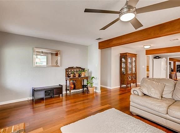 Whoa..Look at these beautiful wood floors.   Beams painted to match the floors  Front Parlor has a ceiling fan.