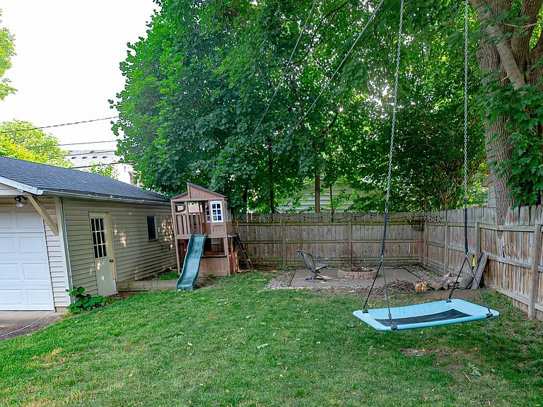 Two car garage and back yard with play area.