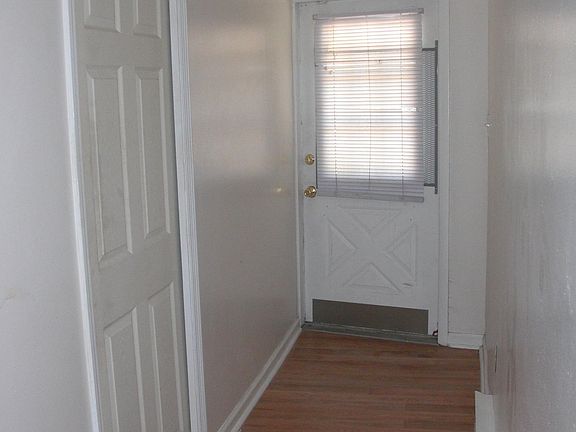 Front door and bedroom door on the left