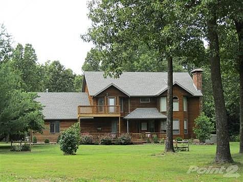 Front view of this custom walkout basement home situated on a beautiful and wooded 10 acres