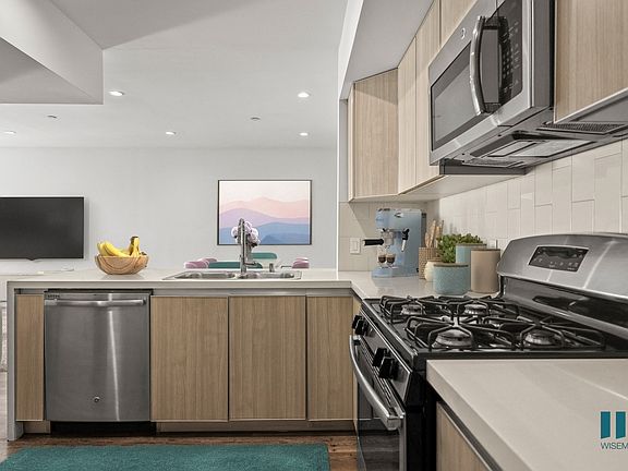 Open-Concept Kitchen with Stainless-Steel Appliances and a Countertop Bar