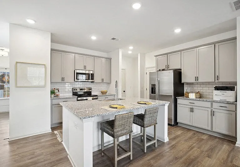 Kitchen island with bar seating. looking into the full kitchen.