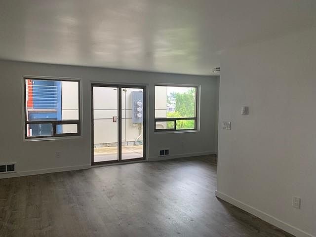 living room and dining room with window blindes