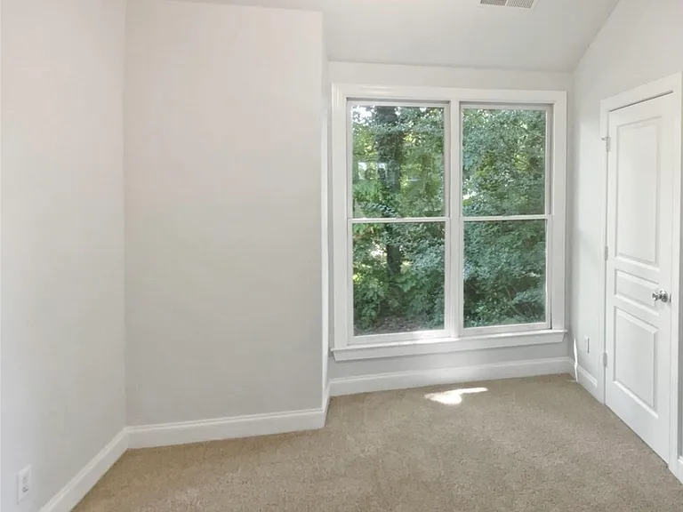 Guest bedroom with nice natural lighting, full bath, and walk-in closet.