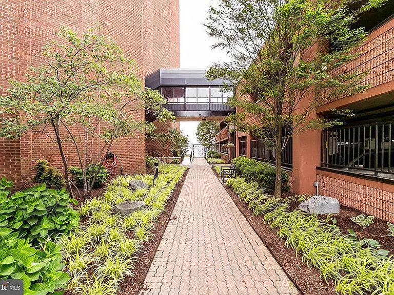 Secure garden and covered walkway between building and garage
