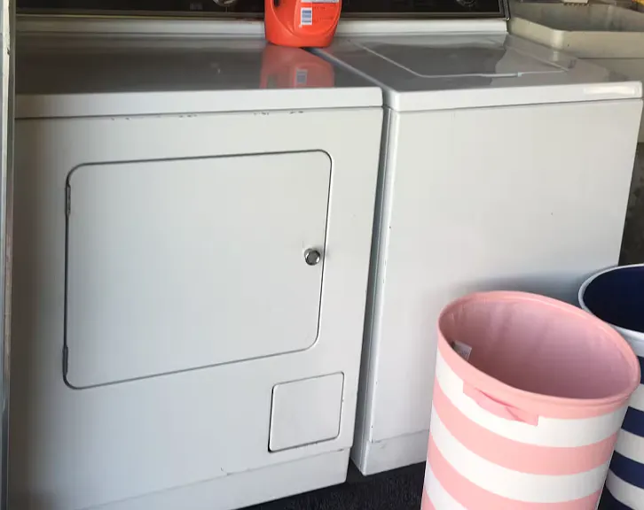 The washing machine and dryer are inside the attached garage.