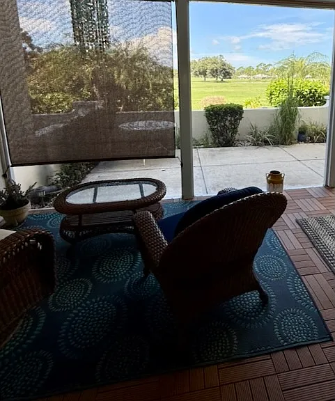 Screened lanai and open patio with golf course views