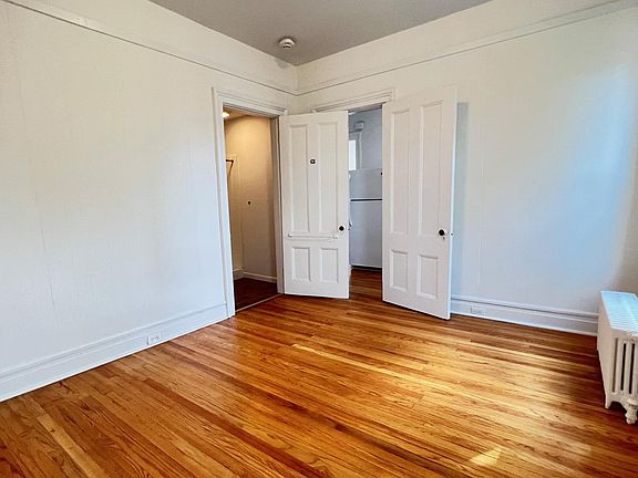 Bedroom with bathroom door (l) and Kitchen door (r)