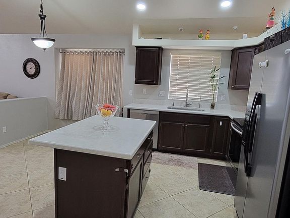 Kitchen with quartz counter tops and extended island for seating.