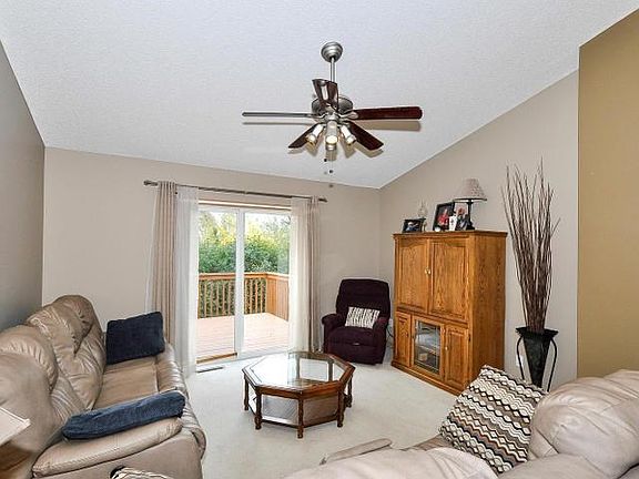 Inviting living room is open and bright with sliding door to deck. Vaulted ceilings add an elegance to the space!