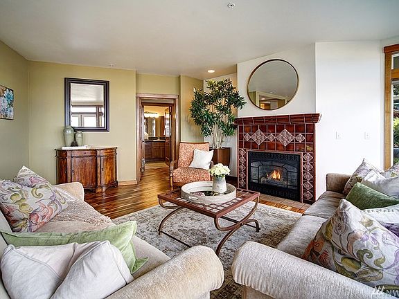 Gas fireplace with custom tile work done by a true artisan!  Tall ceilings too with recessed lighting!