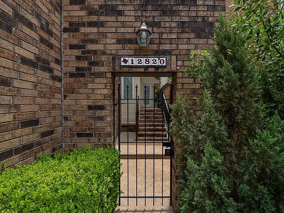 Front gate to the elevated patio home offering this updated 3 bedroom, 3 full bath home with large deck and green space in backyard.