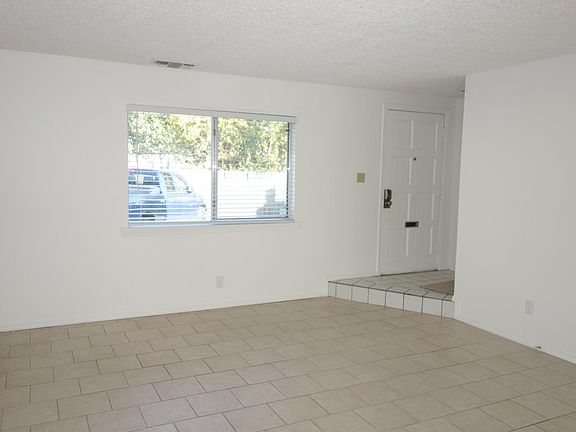 In the Living room facing East, Front window and door visible. Mail Slot on door!