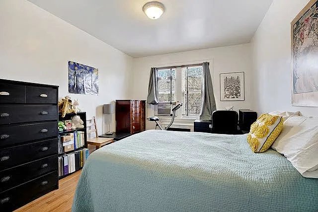 Second bedroom (with previous furniture). Fresh paint, hardwood floors, two windows onto Pratt Blvd