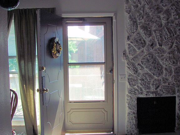 Inside front door. Fire place on RT